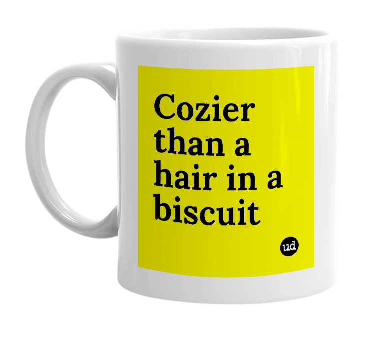 White mug with 'Cozier than a hair in a biscuit' in bold black letters