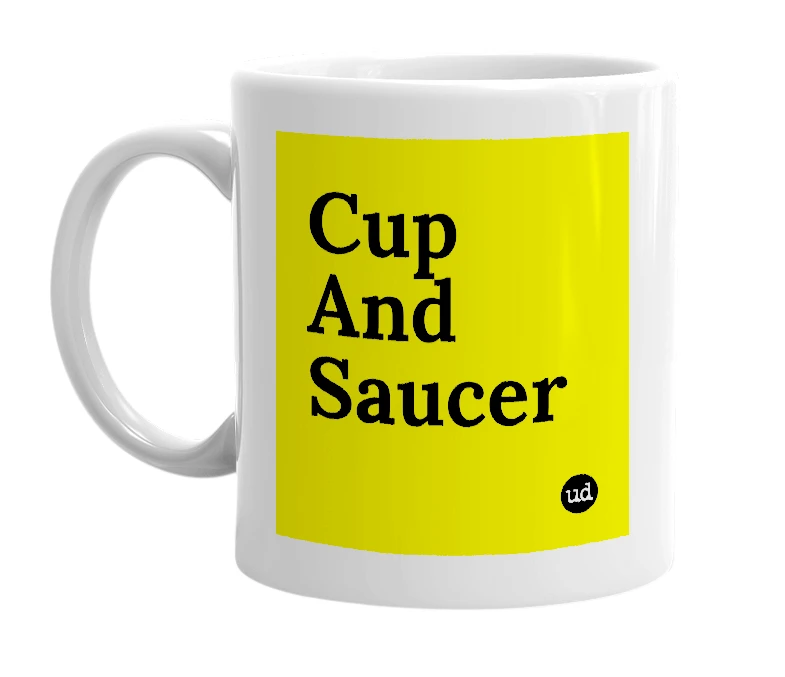 White mug with 'Cup And Saucer' in bold black letters