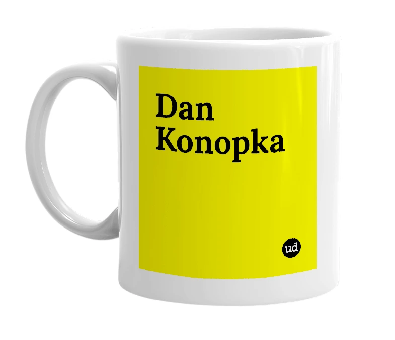 White mug with 'Dan Konopka' in bold black letters