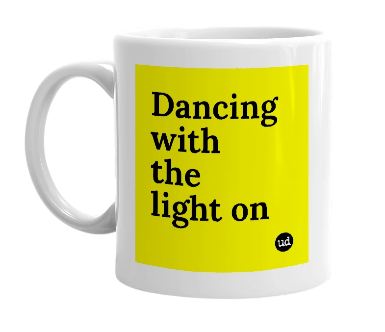 White mug with 'Dancing with the light on' in bold black letters