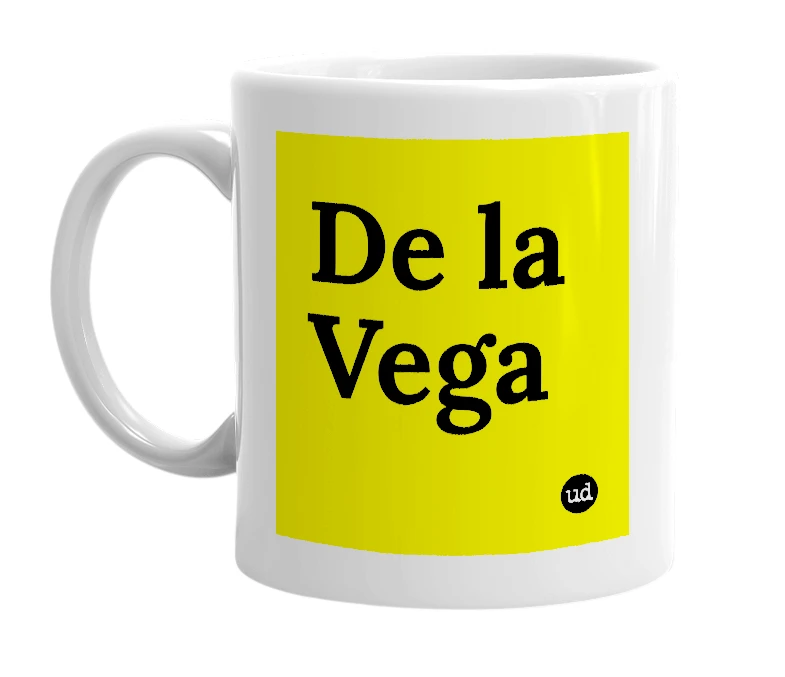 White mug with 'De la Vega' in bold black letters