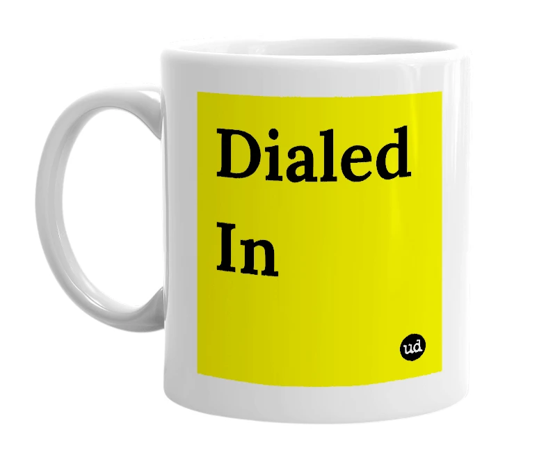 White mug with 'Dialed In' in bold black letters