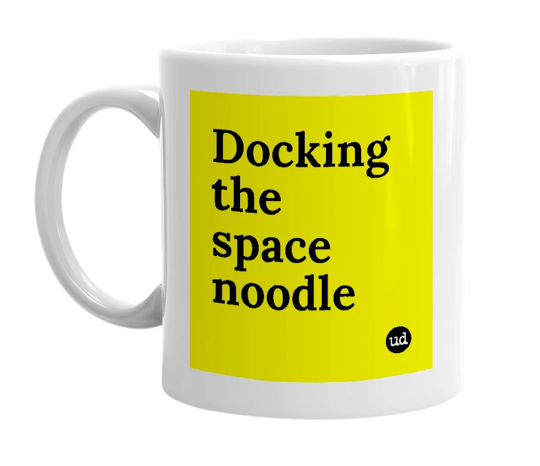 White mug with 'Docking the space noodle' in bold black letters