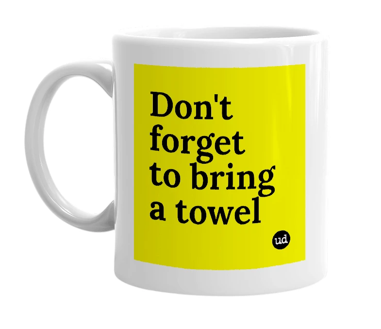 White mug with 'Don't forget to bring a towel' in bold black letters