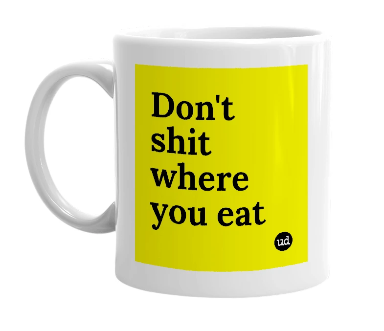 White mug with 'Don't shit where you eat' in bold black letters