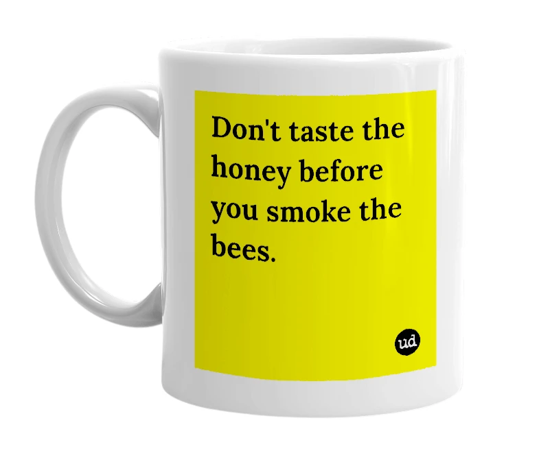 White mug with 'Don't taste the honey before you smoke the bees.' in bold black letters