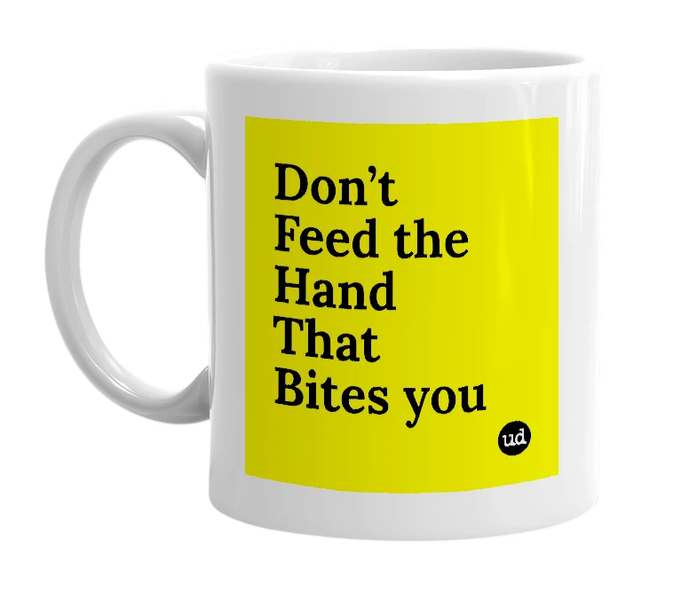 White mug with 'Don’t Feed the Hand That Bites you' in bold black letters