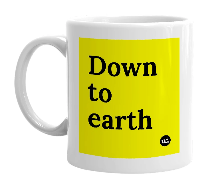 White mug with 'Down to earth' in bold black letters