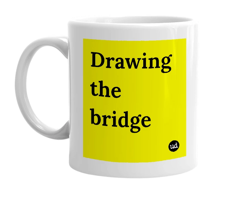White mug with 'Drawing the bridge' in bold black letters