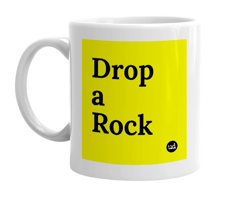 White mug with 'Drop a Rock' in bold black letters