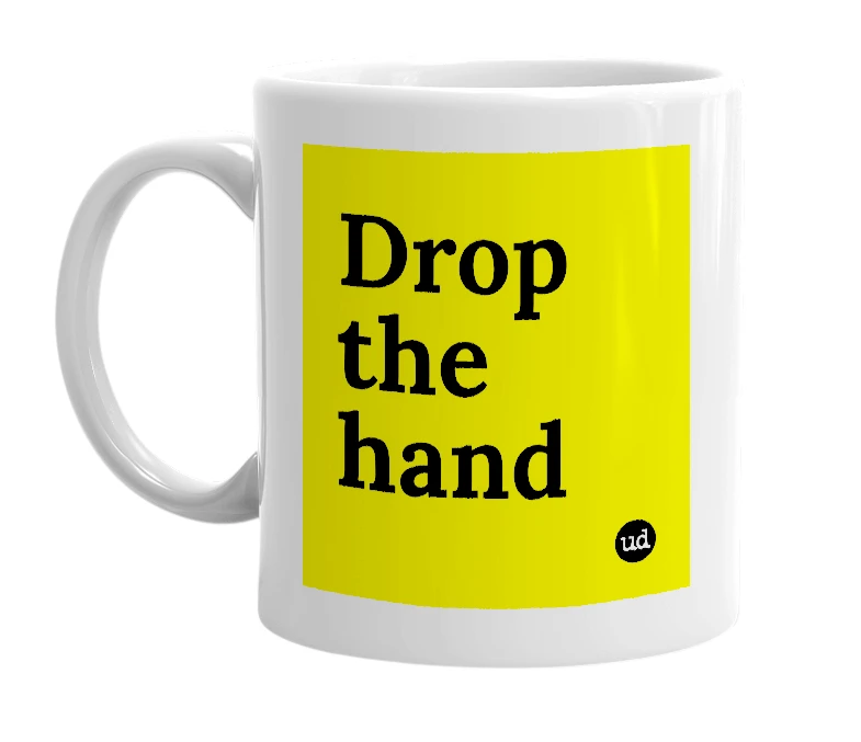 White mug with 'Drop the hand' in bold black letters