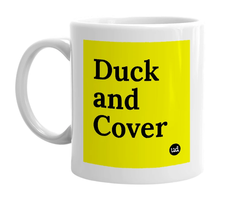 White mug with 'Duck and Cover' in bold black letters