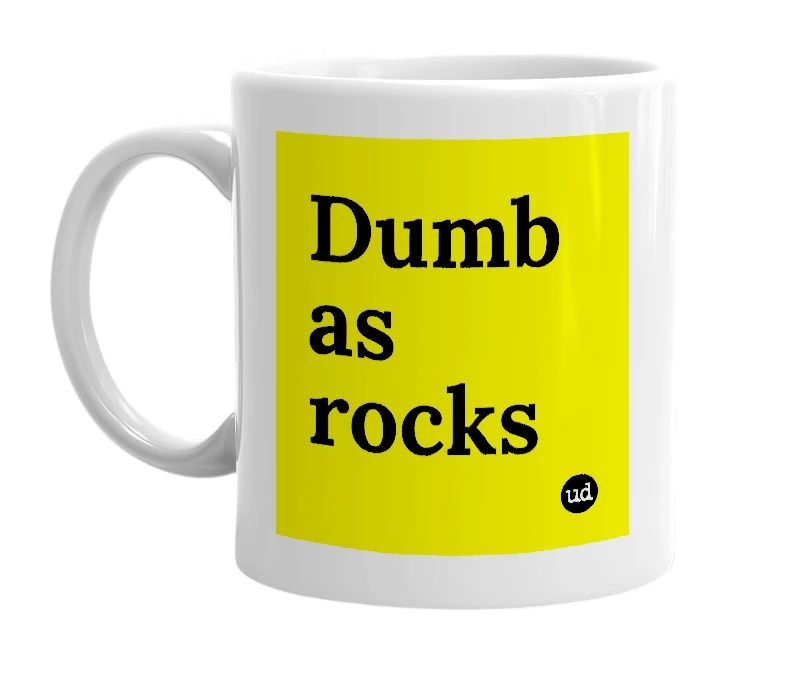 White mug with 'Dumb as rocks' in bold black letters