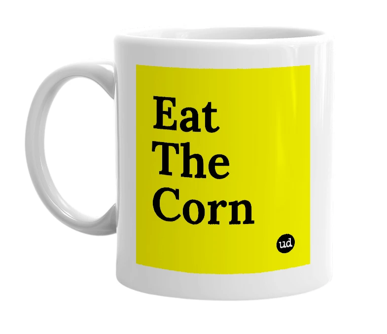 White mug with 'Eat The Corn' in bold black letters