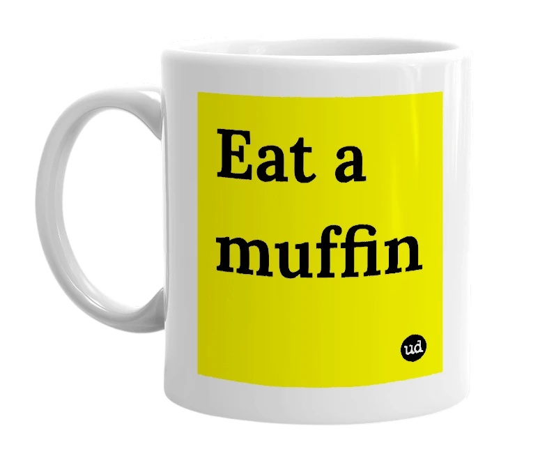White mug with 'Eat a muffin' in bold black letters