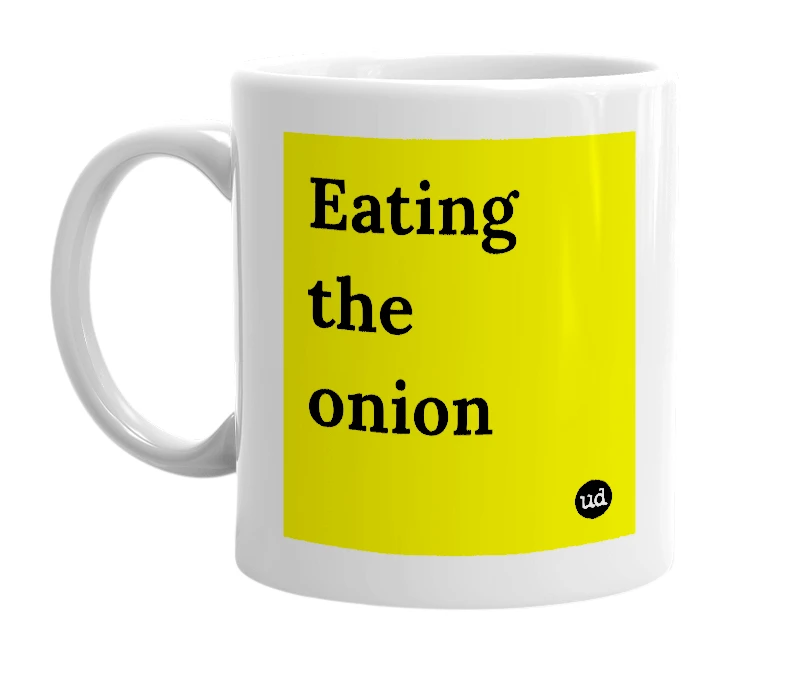 White mug with 'Eating the onion' in bold black letters
