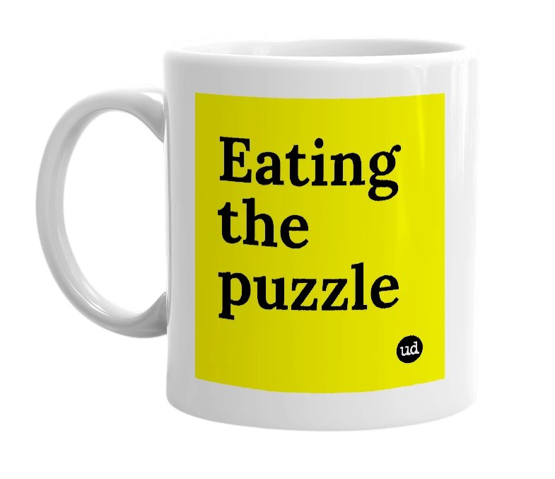 White mug with 'Eating the puzzle' in bold black letters