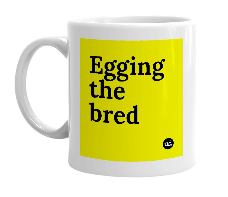 White mug with 'Egging the bred' in bold black letters