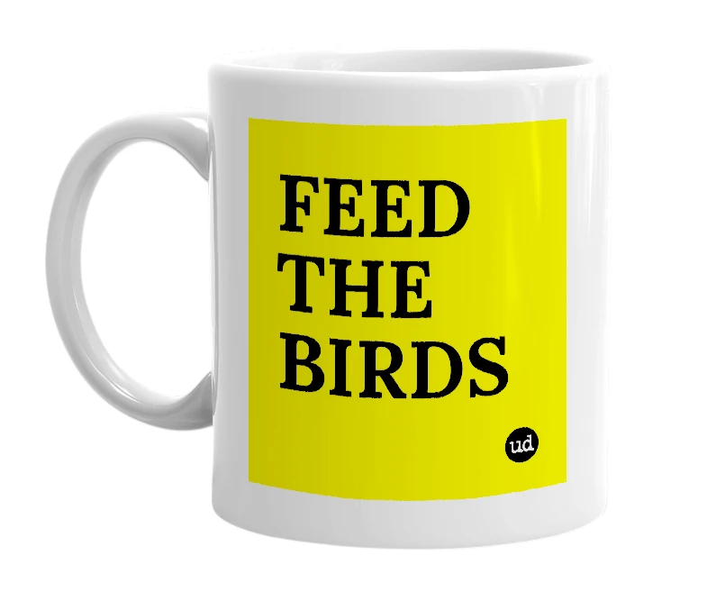 White mug with 'FEED THE BIRDS' in bold black letters