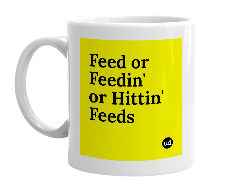 White mug with 'Feed or Feedin' or Hittin' Feeds' in bold black letters
