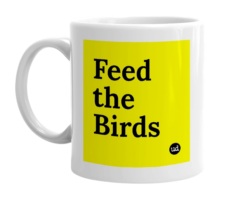 White mug with 'Feed the Birds' in bold black letters