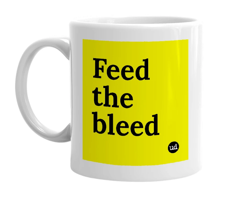 White mug with 'Feed the bleed' in bold black letters
