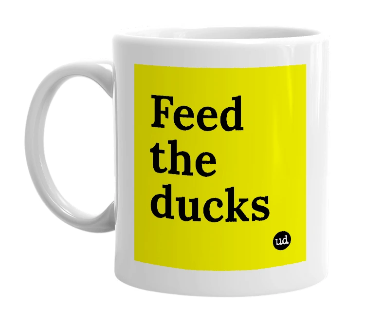 White mug with 'Feed the ducks' in bold black letters