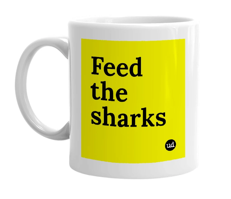 White mug with 'Feed the sharks' in bold black letters