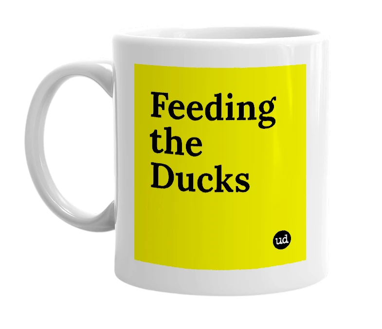 White mug with 'Feeding the Ducks' in bold black letters