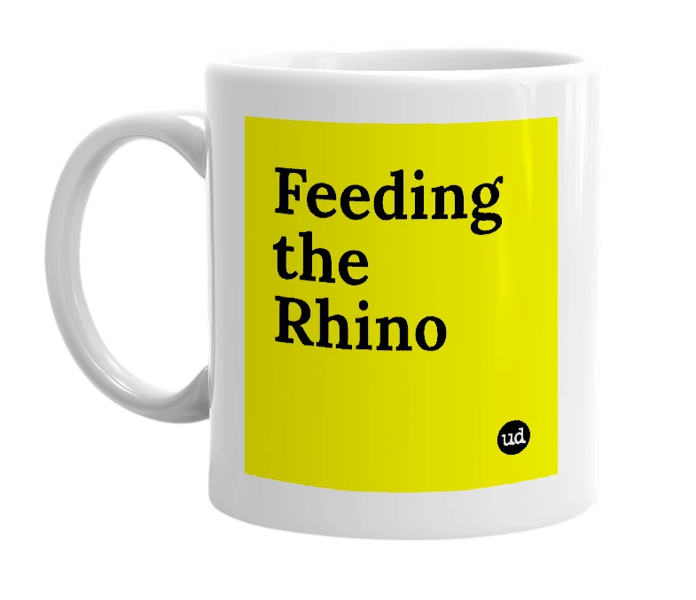 White mug with 'Feeding the Rhino' in bold black letters