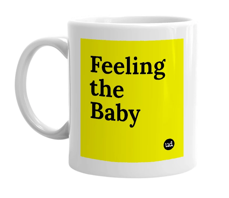 White mug with 'Feeling the Baby' in bold black letters