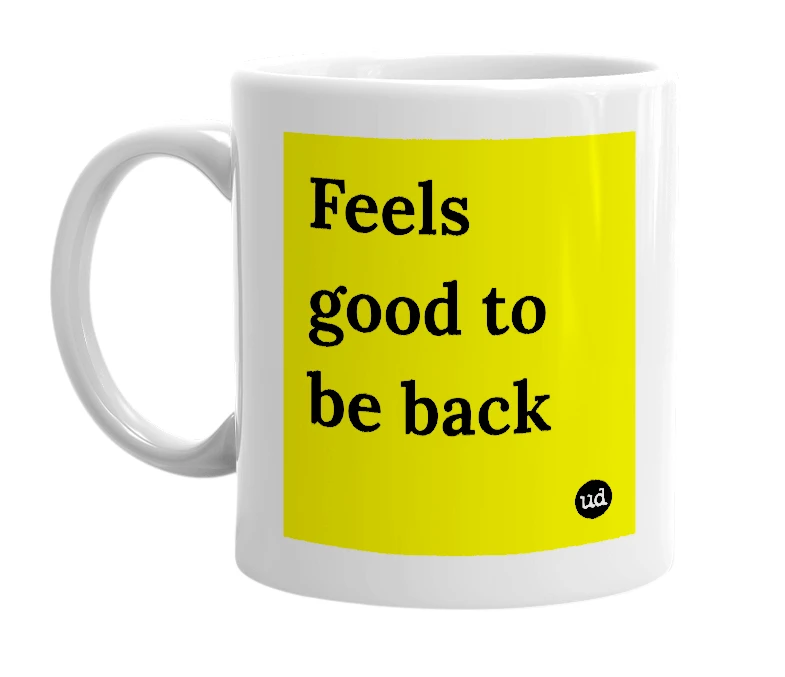 White mug with 'Feels good to be back' in bold black letters