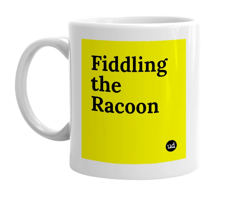 White mug with 'Fiddling the Racoon' in bold black letters