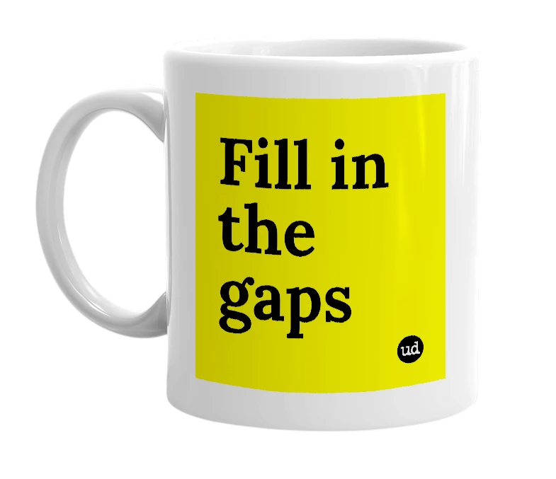 White mug with 'Fill in the gaps' in bold black letters