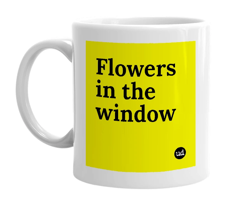 White mug with 'Flowers in the window' in bold black letters