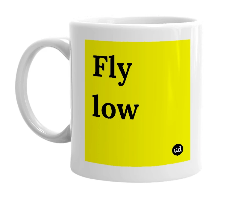 White mug with 'Fly low' in bold black letters