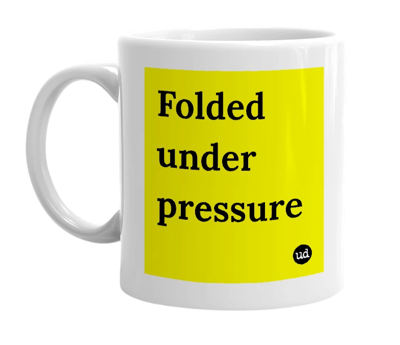 White mug with 'Folded under pressure' in bold black letters