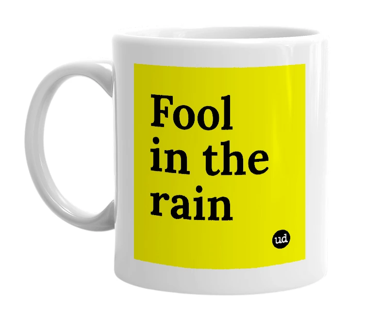 White mug with 'Fool in the rain' in bold black letters