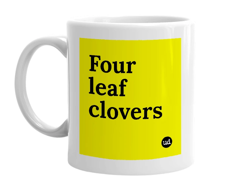 White mug with 'Four leaf clovers' in bold black letters