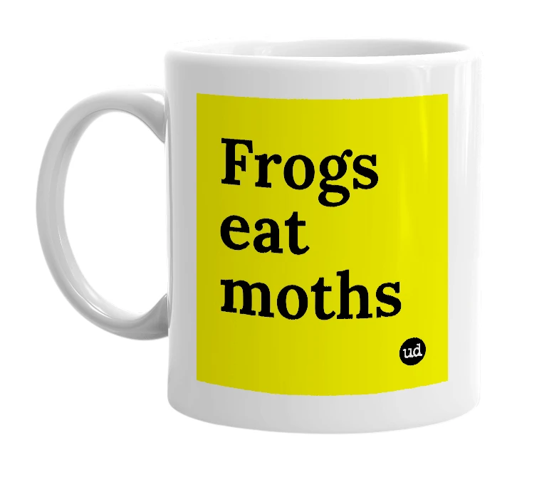 White mug with 'Frogs eat moths' in bold black letters
