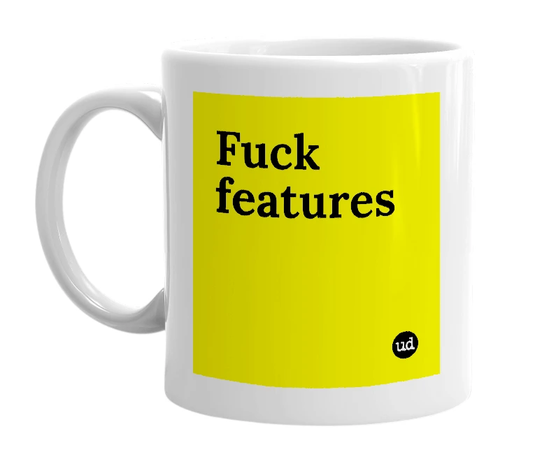 White mug with 'Fuck features' in bold black letters