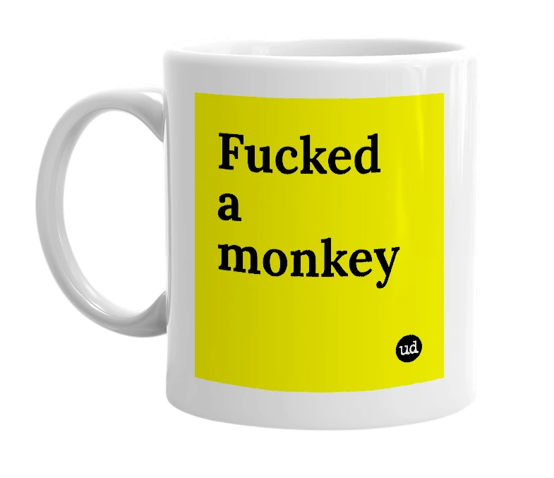 White mug with 'Fucked a monkey' in bold black letters