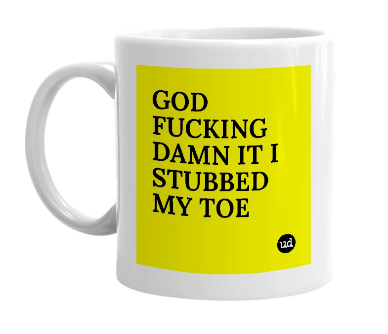 White mug with 'GOD FUCKING DAMN IT I STUBBED MY TOE' in bold black letters