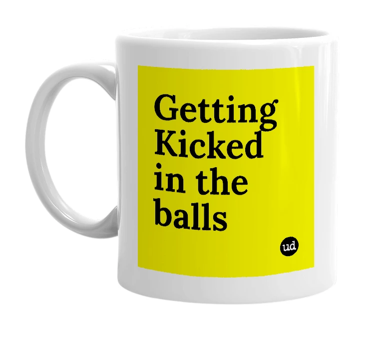 White mug with 'Getting Kicked in the balls' in bold black letters