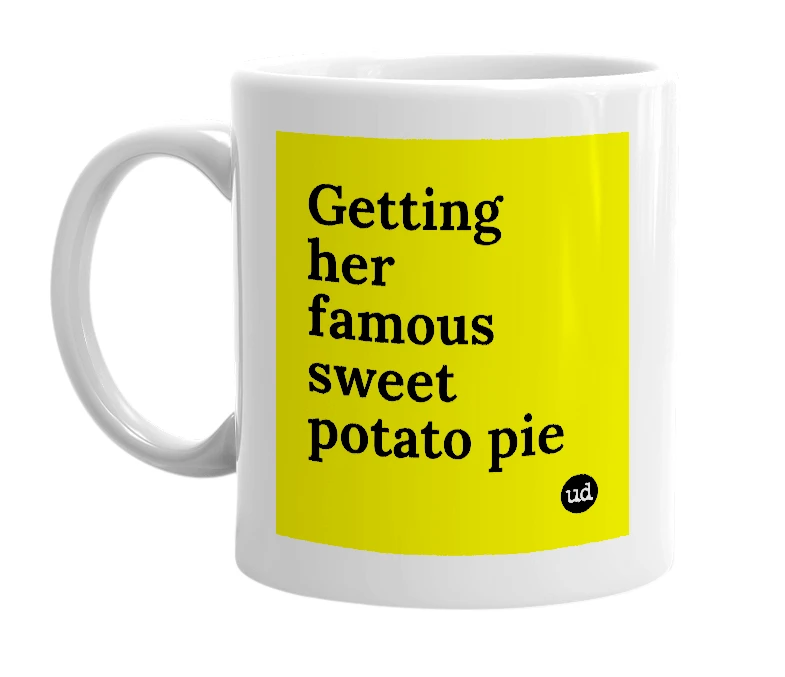 White mug with 'Getting her famous sweet potato pie' in bold black letters