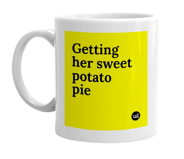 White mug with 'Getting her sweet potato pie' in bold black letters