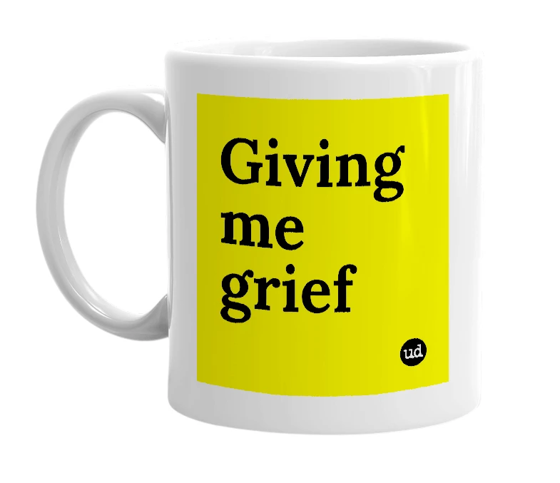White mug with 'Giving me grief' in bold black letters
