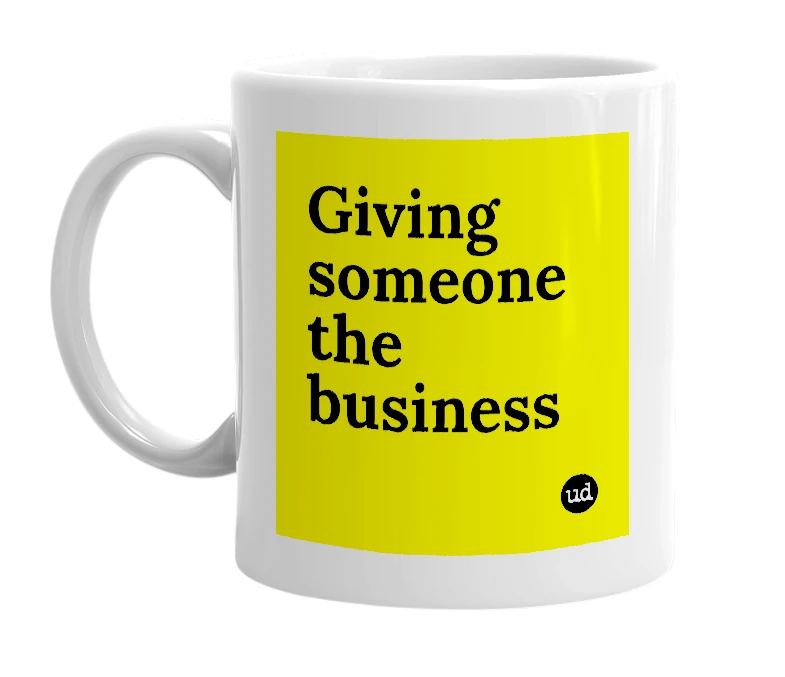 White mug with 'Giving someone the business' in bold black letters