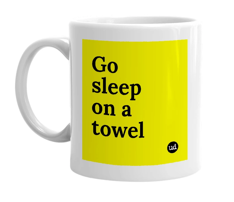 White mug with 'Go sleep on a towel' in bold black letters