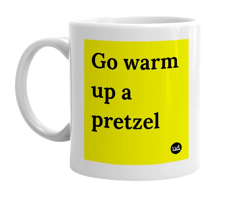 White mug with 'Go warm up a pretzel' in bold black letters